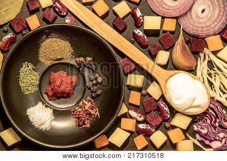 Fresh vegetables for cooking traditional Ukrainian soup, borsch. Wooden spoon with salt and spices