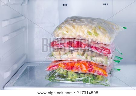 Frozen vegetables in bags in refrigerator. Freezing.