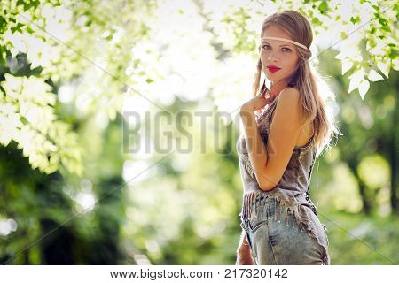Beautiful happy woman speding time in green nature