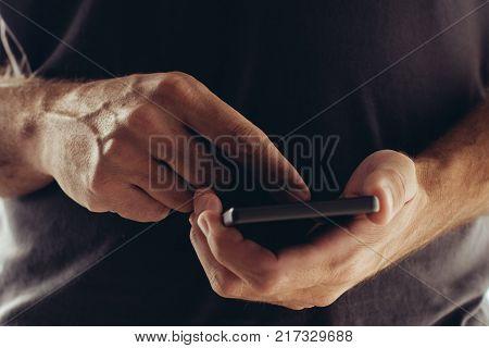 Sexting on mobile phone man using smartphone app to send sexy texts and messages