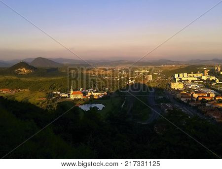 Most Czech republic - July 07 2012: prospect from Hnevin castle to Most city with Kostel Nanebevzeti Panny Marie church during sommer holiday at sunset