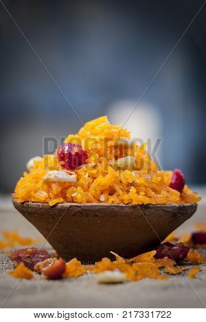 Indian Sweet Rice Dish In A Clay Bowl On Gunny Background.