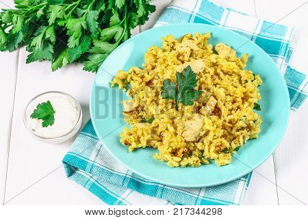 Indian biryani with chicken, yogurt and spices in a plate on a wooden table. New Year's, Christmas dish