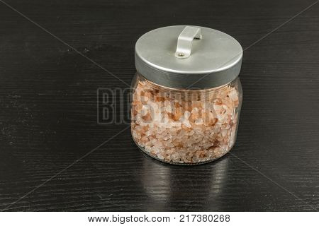 A jar of healthy crystal Himalayan salt.