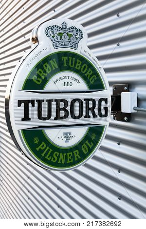 Risskov, Denmark - November 25, 2017: Tuborg beer logo on a wall. Tuborg is a Danish brewing company founded in 1873 on a harbour in Hellerup, Denmark. Tuborg is a part of Carlsberg group