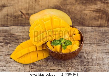 Mango Fruit And Mango Cubes On The Wooden Table