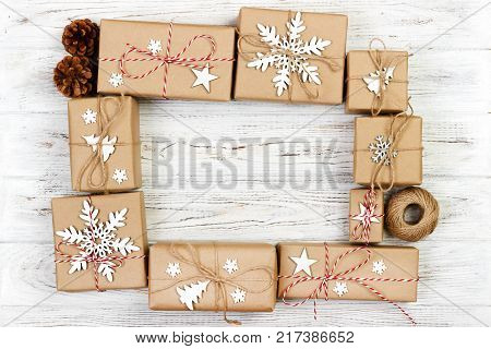 New Year and Christmas Frame Composition. handmade wrapped christmas gift boxes with decoration on white background with empty copy space for your text. above view flat lay.
