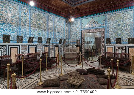 Cairo Egypt - December 2 2017: Manial Palace of Prince Mohammed Ali. The mirrors room at the residence building with Turkish floral blue pattern ceramic tiles wall and decorated wooden ceiling