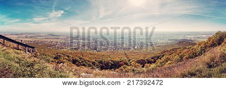 Panoramic view of the Nitra city from Zobor hill Slovak republic. Seasonal landscape. Autumn forest. Tourism theme. Red photo filter.