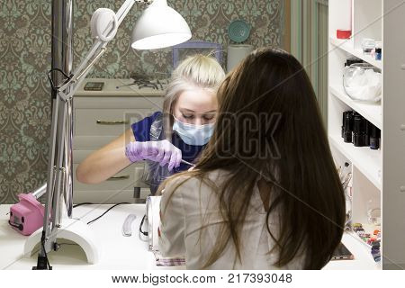 Cute Girl Master Doing A Manicure.