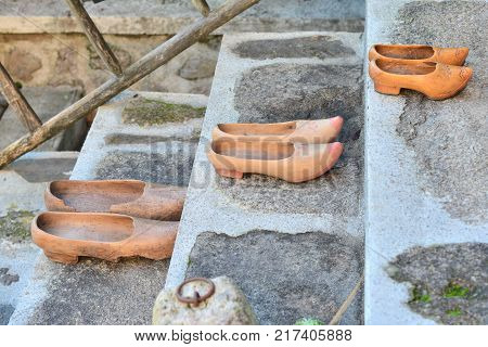 Different vintage dutch wooden clogs on tha stairs