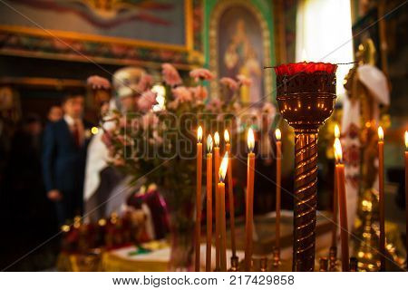 beautiful wedding newlyweds with candles in a church