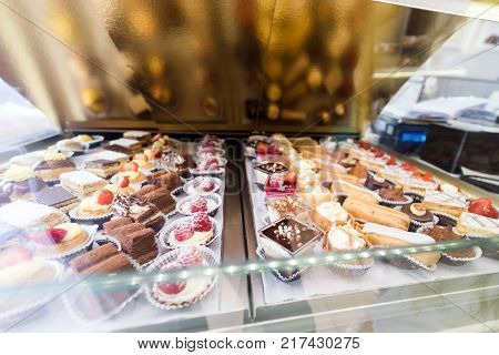 Lots of colorful and tasteful cakes in a patisserie shop delicious cakes