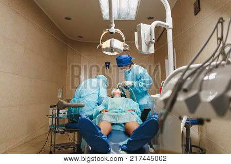 Close Up Process Of Male Professional Dentist Surgeon Performing Operation Install Dental Implant Te