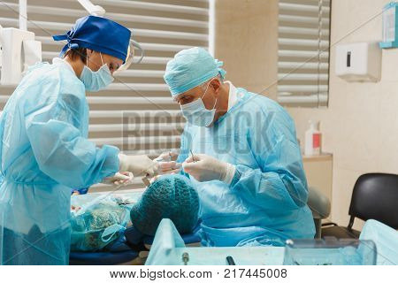 Close Up Process Of Male Professional Dentist Surgeon Performing Operation Install Dental Implant Te