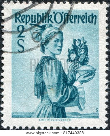 AUSTRIA - CIRCA 1948: A stamp printed in Austria shows a woman in national dress Upper Austria circa 1948