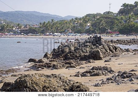 Coastal village by the Mexican Pacific Ocean with rocky foreground