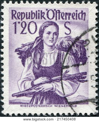 AUSTRIA - CIRCA 1949: A stamp printed in Austria shows a woman in national dress Lower Austria Vienna Woods circa 1949