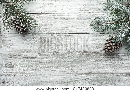 Christmas background with fir tree and decoration on dark wooden board. Christmas, New Year's composition with copy space for text. Flat lay, top view