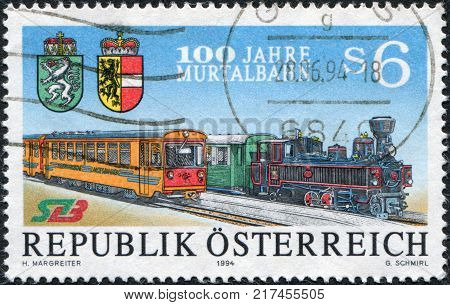 AUSTRIA - CIRCA 1994: A stamp printed in Austria is dedicated to the 100th anniversary of Murtalbahn shows steam locomotive and multiple unit circa 1994