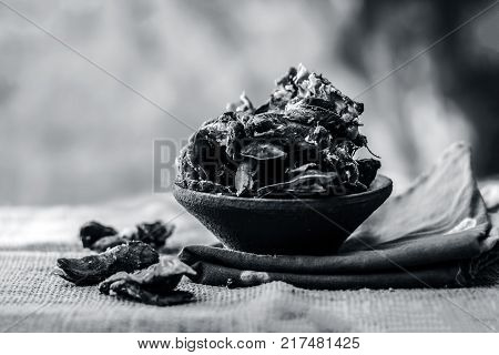 Raw Tamarindus indica,tamarind in a clay bowl on gunny background.