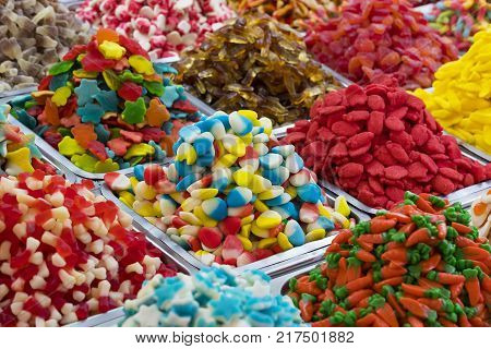Assortment of jellied colored sweets as a product background