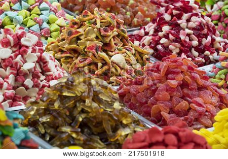 Assortment of jellied colored sweets as a product background