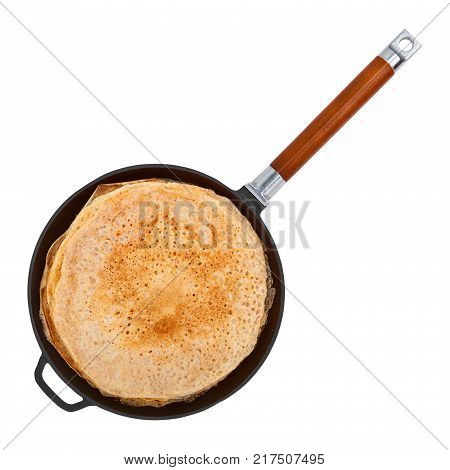 Crepes in a cast iron pan isolated on white background top view