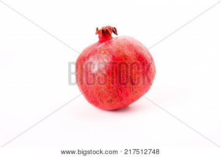 fresh red pomegranate isolated on white background