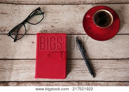 organizer and a cup of coffee on the wooden table