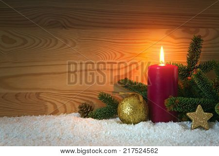 Avent candle and christmas decoration isolated on wood background. Christmas background with snow, candle and stars.