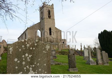 A view across a graveyard toward a ruined church building in Bankfoot, Perthshire
