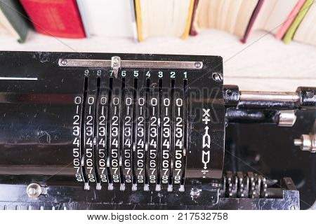 Old Rusty Retro Calculator Black Standing On A Wooden Table