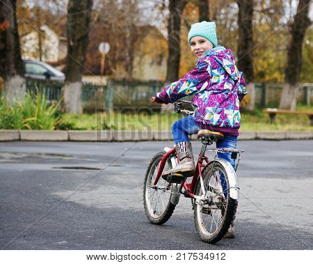 Child on a bicycle on an asphalt track.