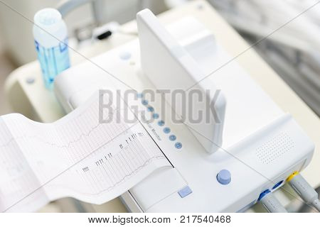 Cardiotocograph device  in a hospital  to examine  fetus heartbeat and make cardiogram while pregnancy .