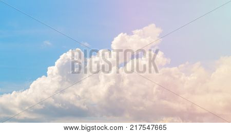 White cloud on blue sky. Cloudscape photo background. Romantic skyscape with cloud and pink sun flare. Stormy cloud on sunny sky. Climate or weather change. Moisture concept. Fluffy cloud closeup