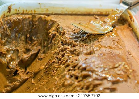 large containers with a sweet toffee-like honey or boiled milk and a spoon