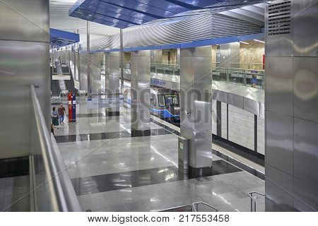 MOSCOW, AUG, 22, 2017: Metro station Business Center. Two levels floors metro station, blue train and train waiting people. Metallic railway station. New modern metro station metal architecture