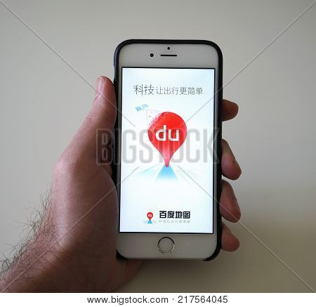 Wuhan China, 9 December 2017: Man holding smartphone with Baidu ditie Chinese map app on loading screen with Baidu maps logo