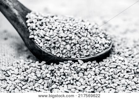 Fenugreek Seeds In A Wooden Scoop On A Gunny Background.