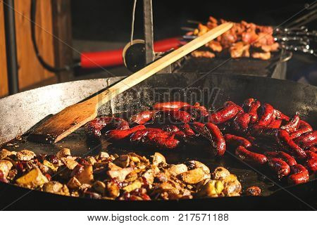 Street food at the fair Wok frying sausages yummy