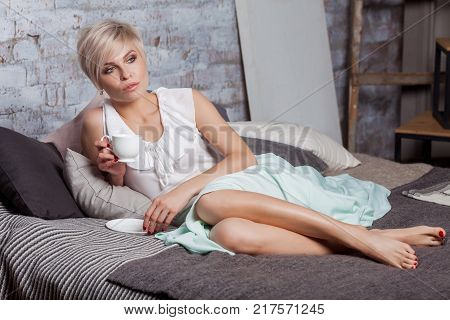 Beautiful Woman Sitting On Leather Sofa