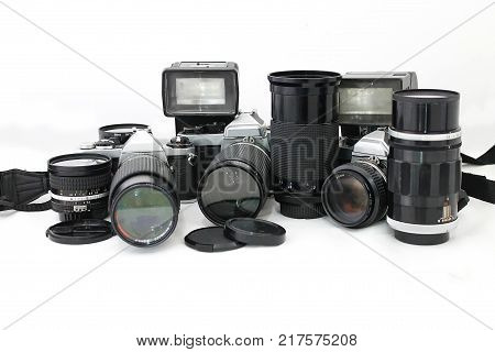Set of old camera with lenses and a flash camera isolated on white background