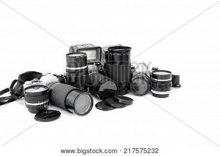 Set of old camera with lenses and a flash camera isolated on white background