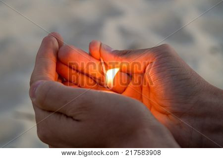 Right hand of adult man hold one match with road background.