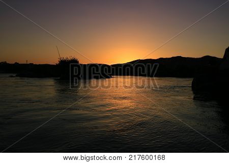 Silhouette sunset on the river.There is light reflecting on the water.It's the last light of the day. The beautiful and natural.