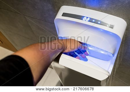 Modern Vertical Hand Dryer In Public Restroom