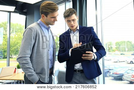 Two businessman dicussing business in the office