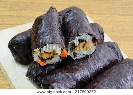 Japanese Cuisine Traditional Vagetarian Japanese Rice Maki Sushi Roll Stuff with Tofu and Carrot Wrapped in Nori Seaweed.
