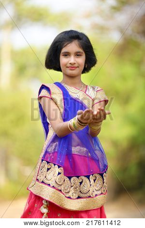 young happy indian child posing on saree